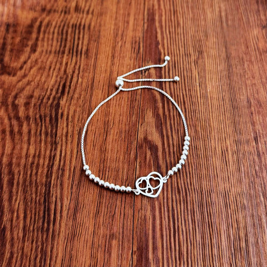 PULSERA TRIPLE CORAZON ENCAPSULADO